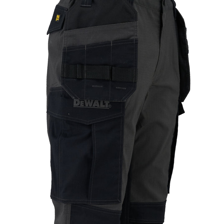 Black work pants with multiple pockets and a visible Dewalt logo on a white background
