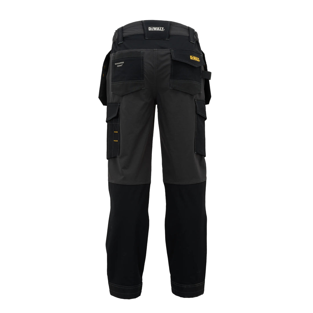 Black and dark gray DeWalt work pants shown from the back, featuring multiple utility pockets and a waist belt, on a solid white background.