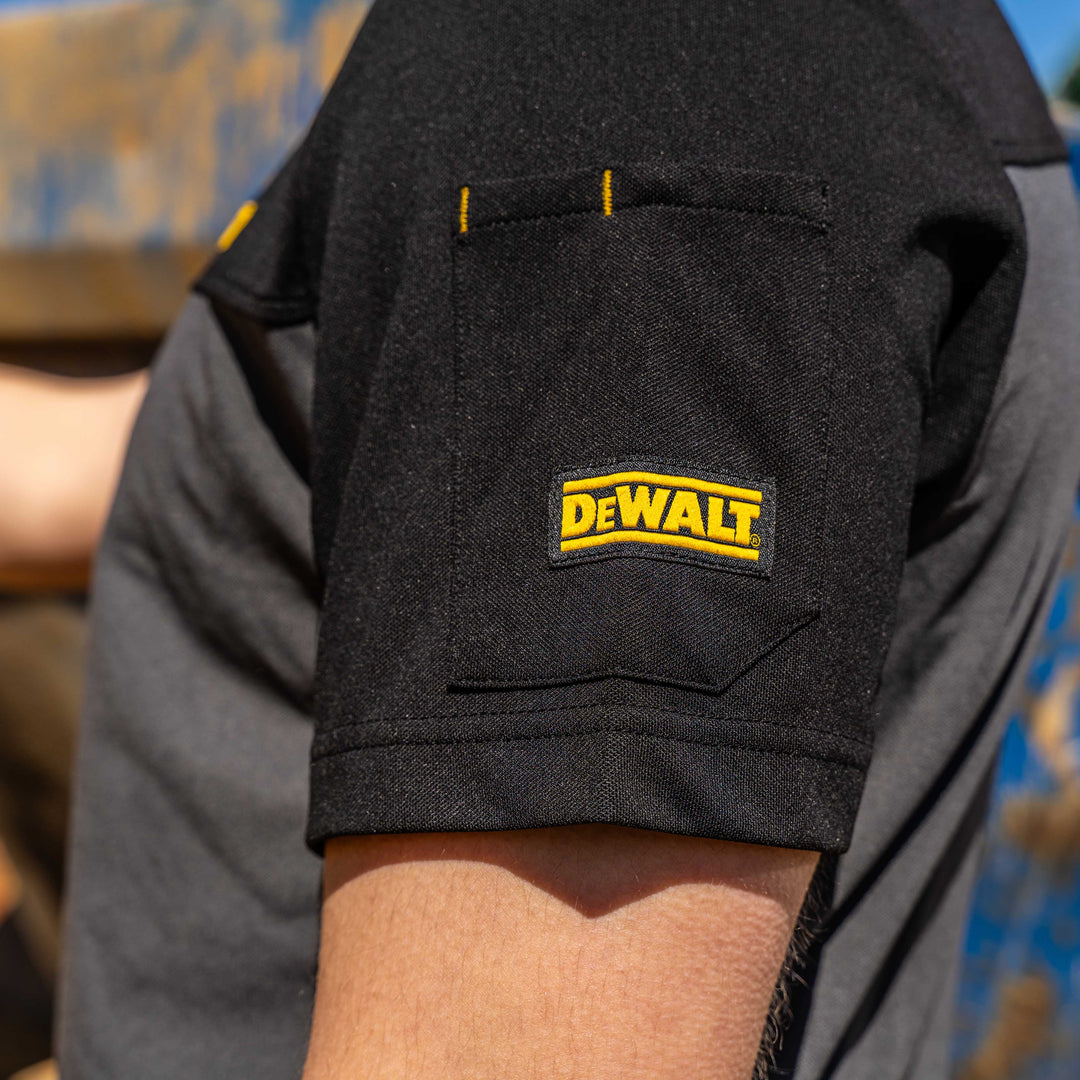 Black pocket with Dewalt logo on a person wearing a gray shirt.
