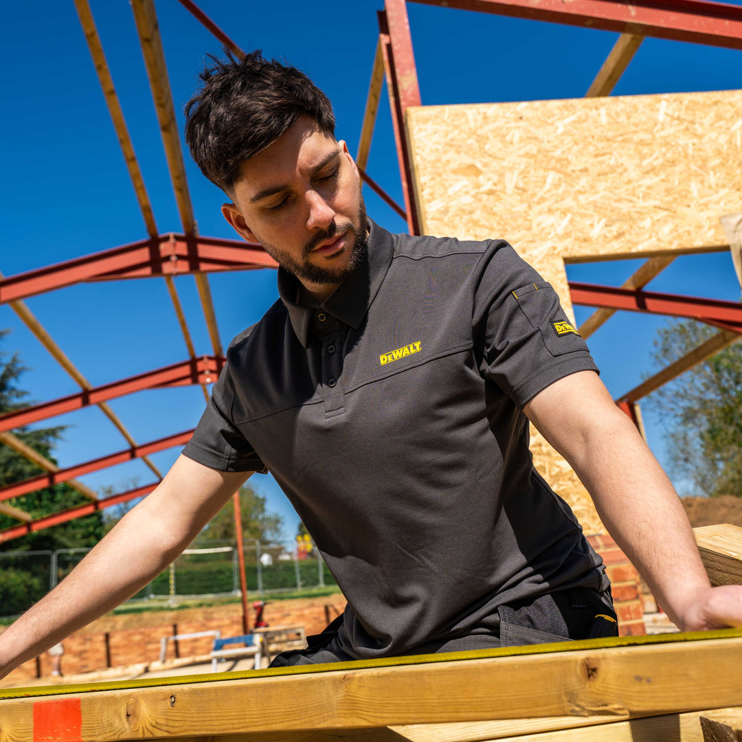 Man working on a construction site wearing a Dewalt shirt.
