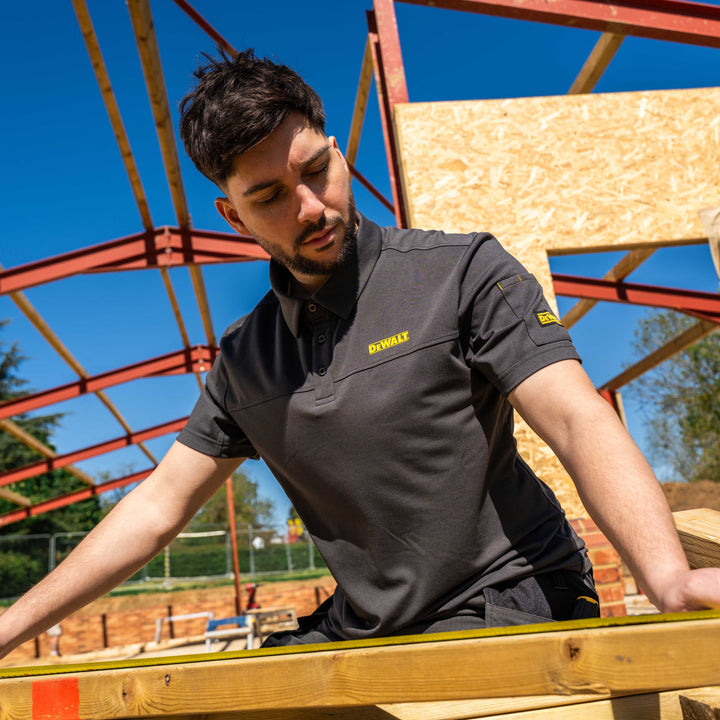 Man working on a construction site wearing a Dewalt shirt.