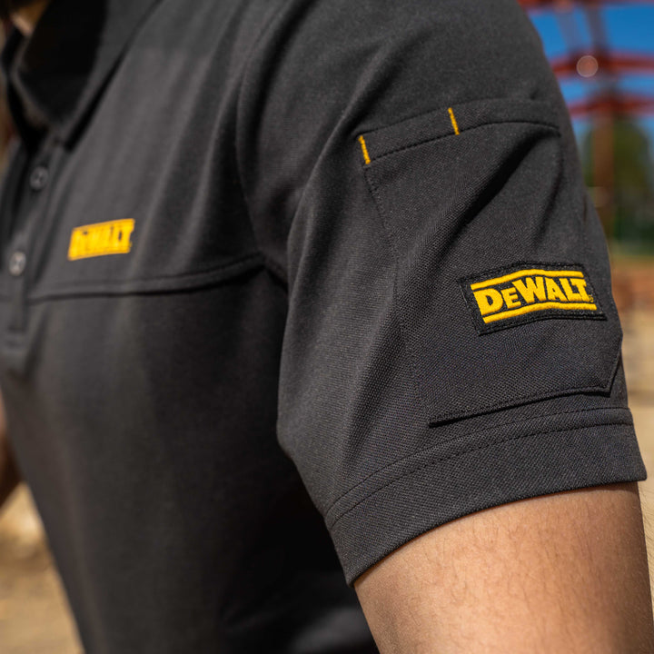 Grey polo shirt with yellow 'DeWalt' logo on sleeves and chest.