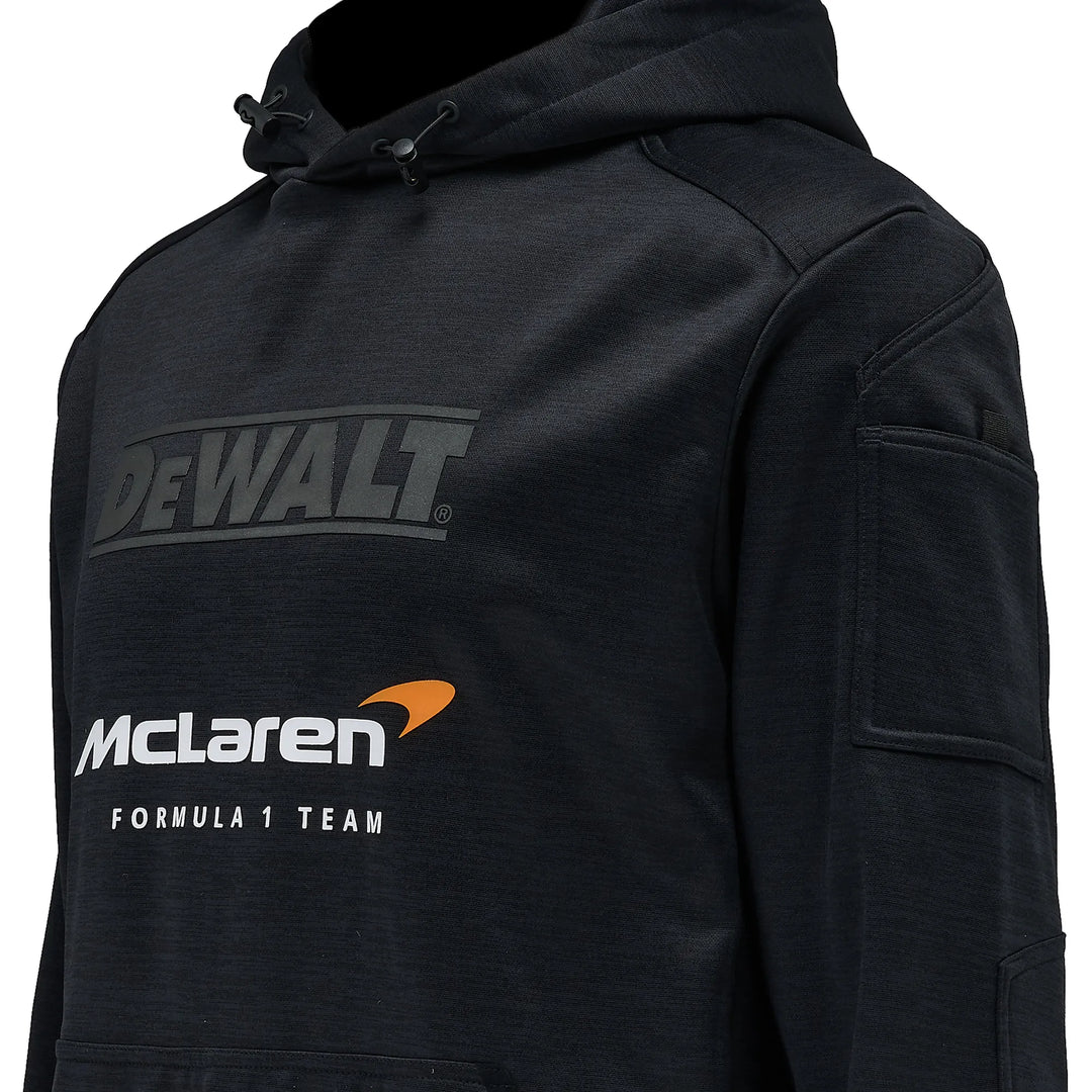 A close-up of a black hooded sweatshirt featuring a dark gray 'DEWALT' logo on the chest and a white 'McLaren Formula 1 Team' logo with an orange accent on the front.