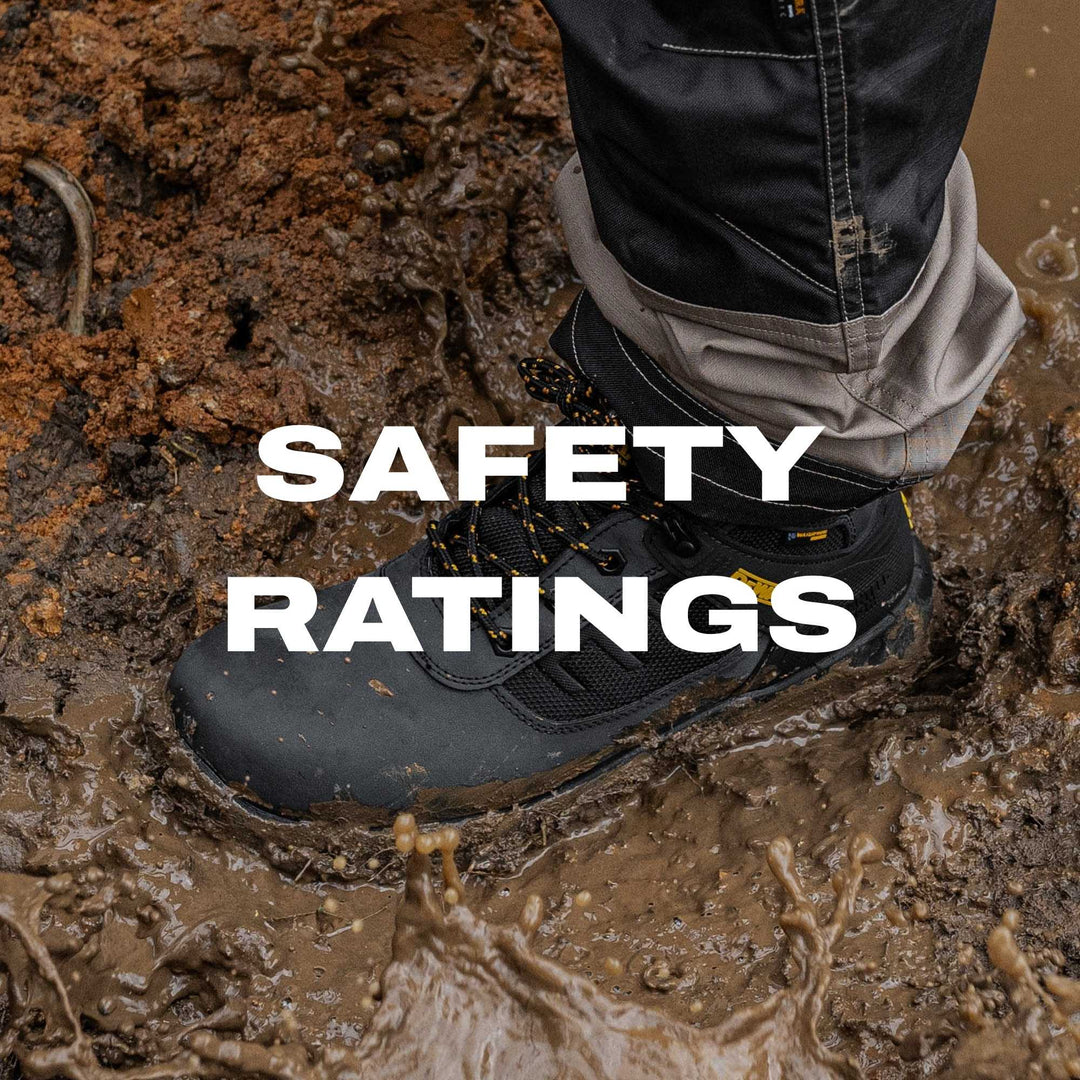 Person wearing a black safety shoe in mud with 'SAFETY RATINGS' text overlay