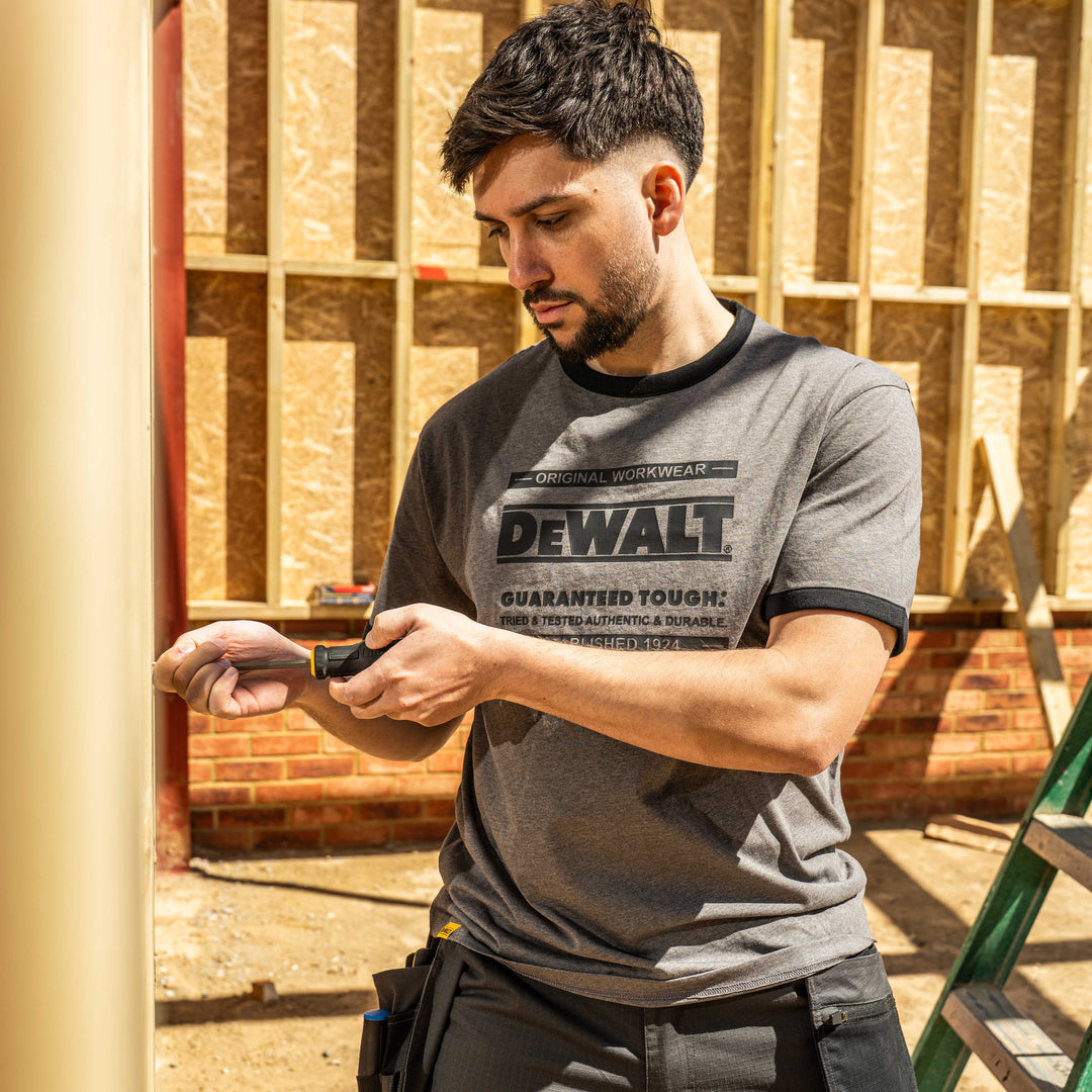 Man wearing a DEWALT t-shirt in a construction setting